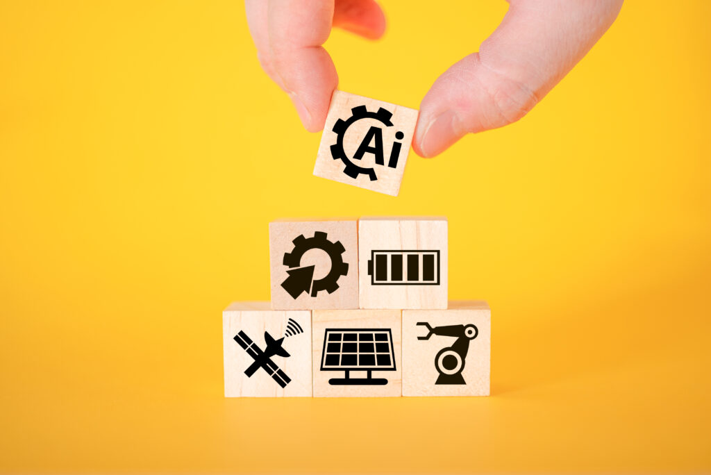 technology concept with icons on wooden cubes, yellow background.