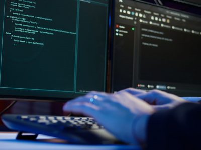 cybercriminal breaching security systems while hiding in secret hq, close up